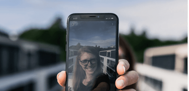 Woman showing her phone with her personalized, good morning text message.