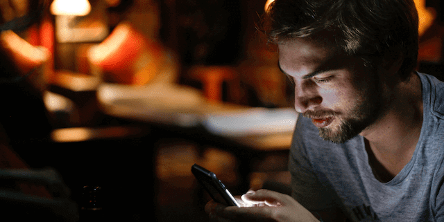 Man reading one his 10 sexy good morning text messages.