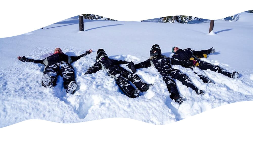 Friends laying on snow.